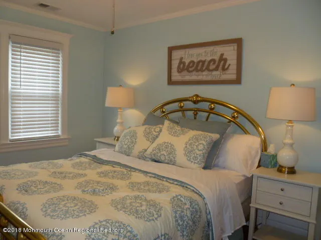 a bedroom with a bed and wall painting