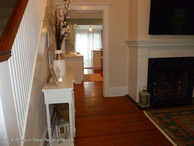 422 Worthington Avenue, Unit SUMMER 2026 Spring Lake, NJ 07762 - Photo 3 of 57 a view of a livingroom with furniture wooden floor fireplace and staircase