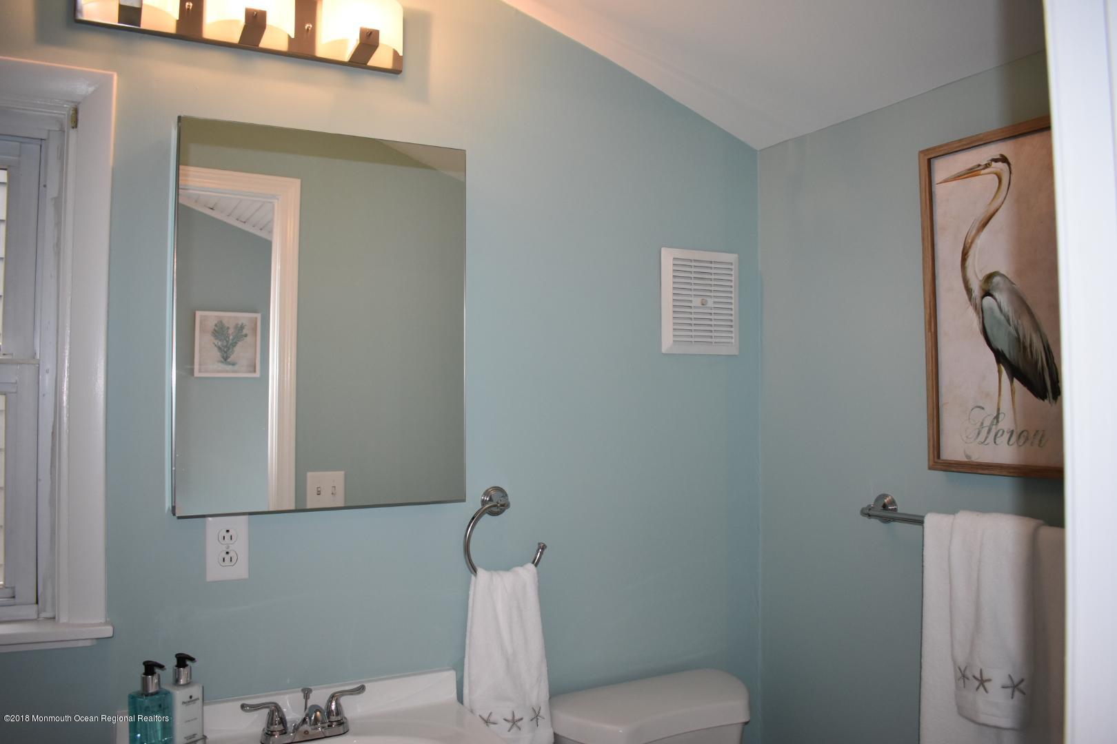 422 Worthington Avenue, Unit SUMMER 2026 Spring Lake, NJ 07762 - Photo 33 of 57 a bathroom with a toilet a sink and mirror