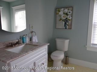 422 Worthington Avenue, Unit SUMMER 2026 Spring Lake, NJ 07762 - Photo 34 of 57 a bathroom with a toilet a sink and mirror