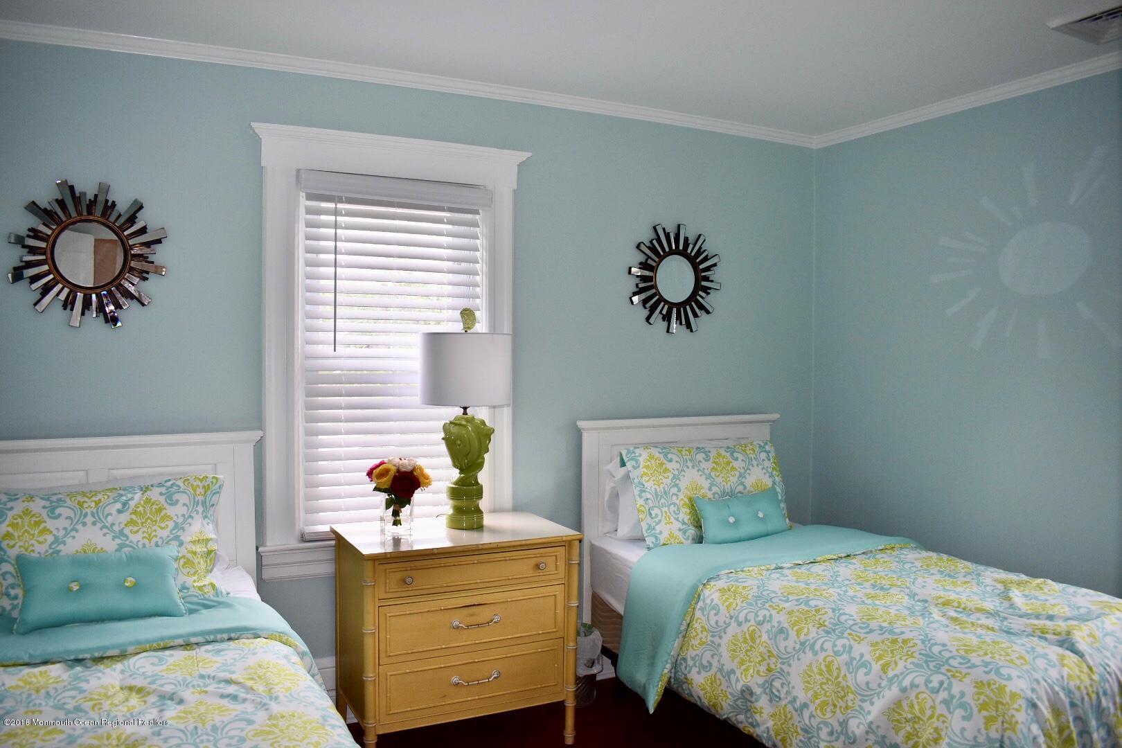 422 Worthington Avenue, Unit SUMMER 2026 Spring Lake, NJ 07762 - Photo 36 of 57 a bedroom with a bed and a window