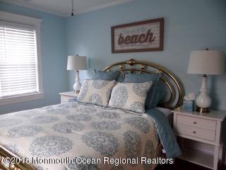 422 Worthington Avenue, Unit SUMMER 2026 Spring Lake, NJ 07762 - Photo 49 of 57 a bed room with a bed and a night stand