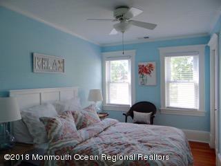 422 Worthington Avenue, Unit SUMMER 2026 Spring Lake, NJ 07762 - Photo 50 of 57 a bed sitting in a bedroom next to a window