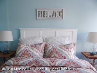 422 Worthington Avenue, Unit SUMMER 2026 Spring Lake, NJ 07762 - Photo 51 of 57 a bed sitting in a bedroom with a white comforter and pillows