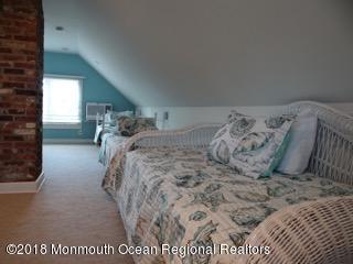 422 Worthington Avenue, Unit SUMMER 2026 Spring Lake, NJ 07762 - Photo 53 of 57 a bed sitting in a bedroom next to a window