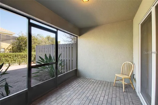 a view of a two room with wooden floor and door