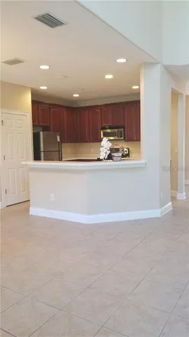 a view of kitchen with kitchen island and stainless steel appliances
