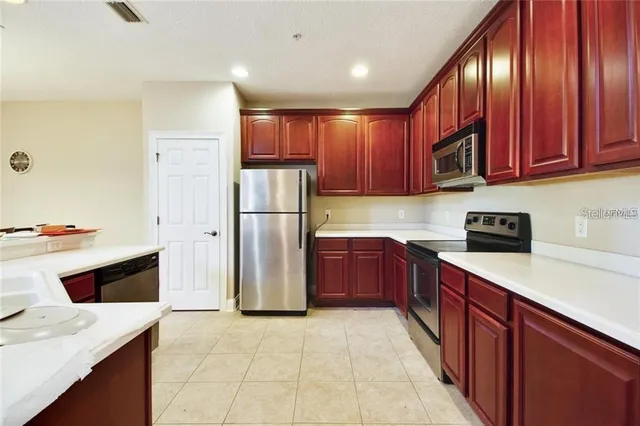 a kitchen with a refrigerator sink and cabinets