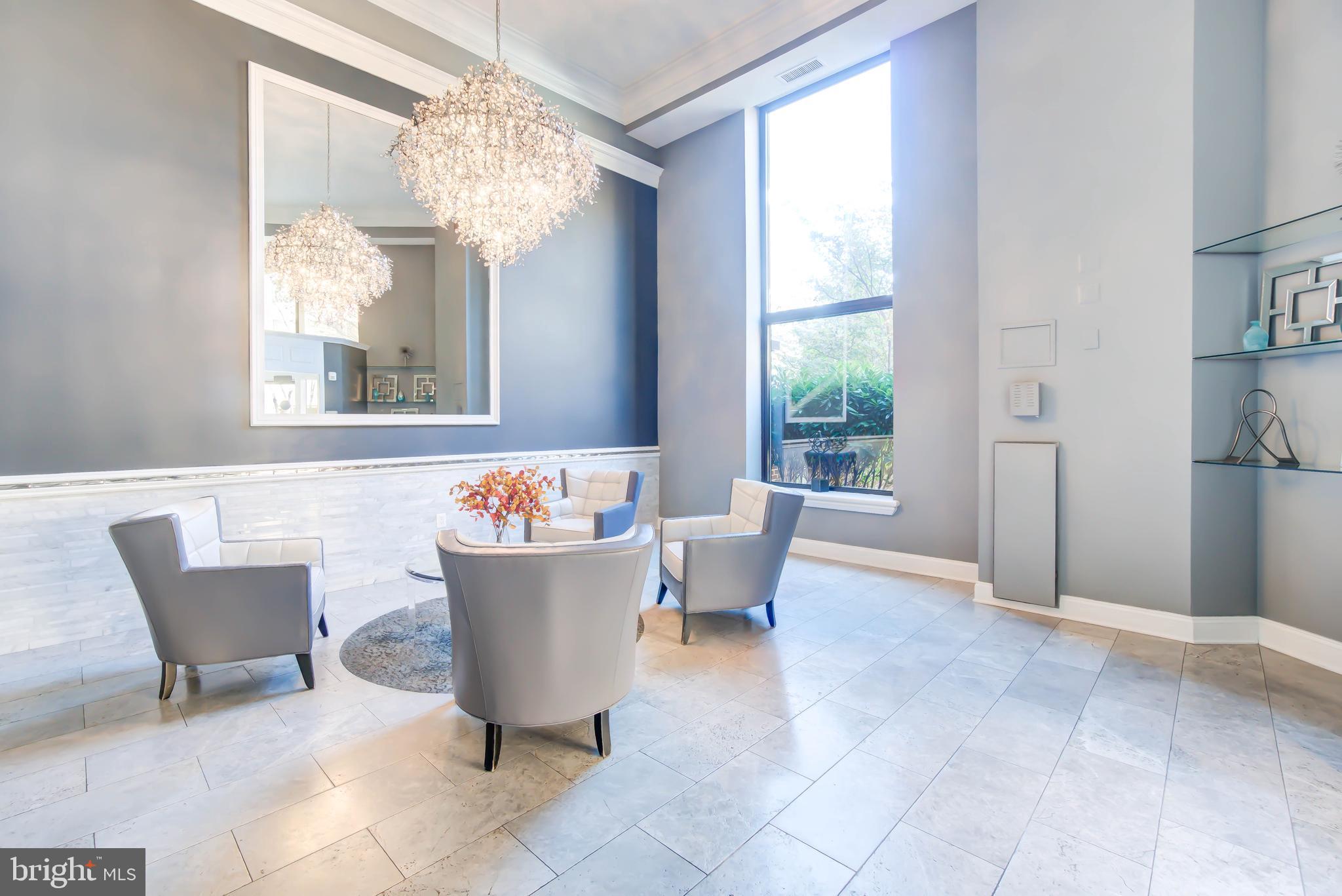 2111 Wisconsin Avenue Northwest, Unit 302 Washington, DC 20007 - Photo 18 of 23 a view of a dining room with furniture wooden floor and chandelier