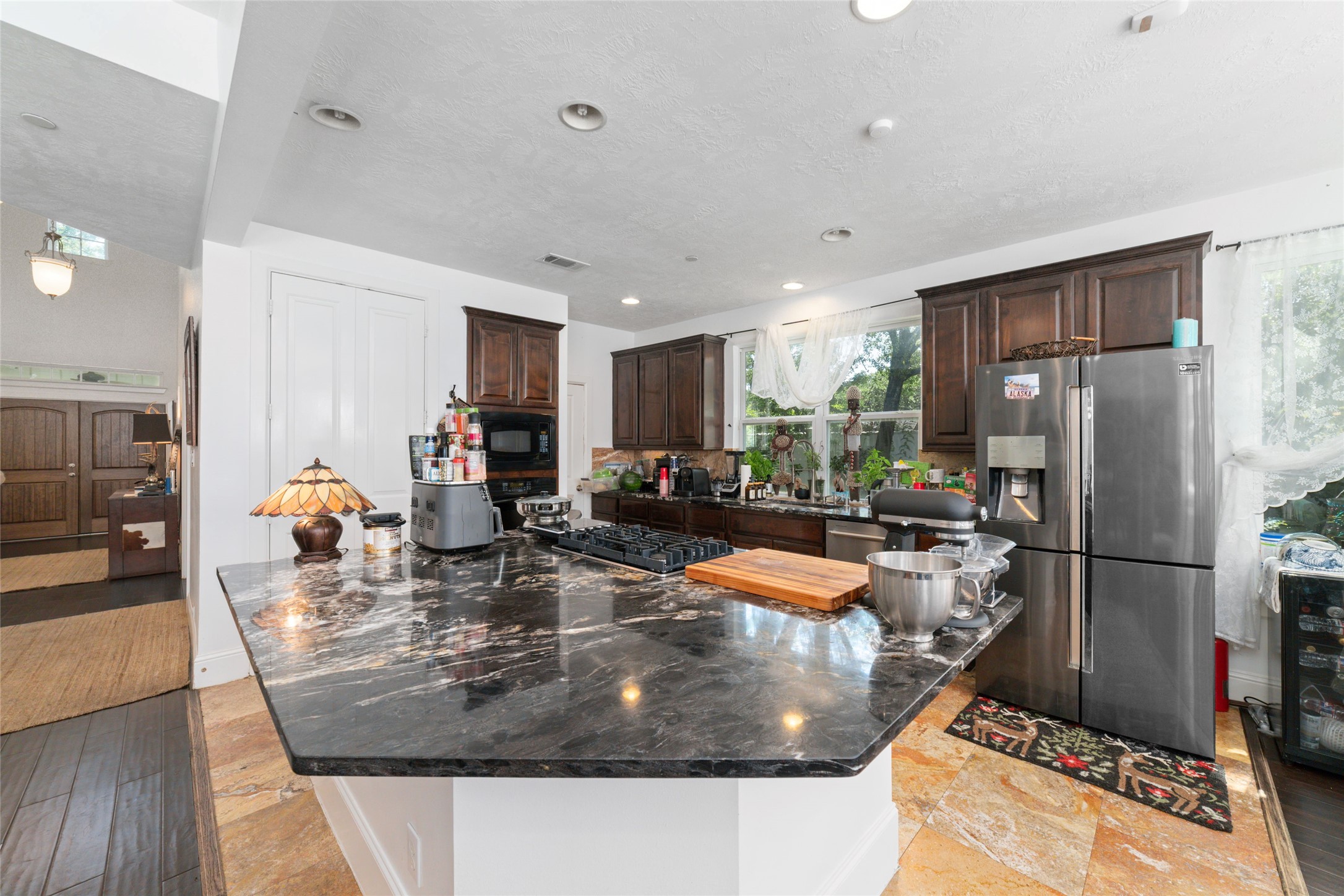 335 Voss Road Houston, TX 77024 - Photo 23 of 45 a kitchen with stainless steel appliances granite countertop a sink a refrigerator and a stove