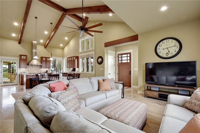 633 Trails End Road Johnson City, TX 78636 - Photo 6 of 29 Exposed wood beams and vaulted ceilings define this welcoming open-concept living space.