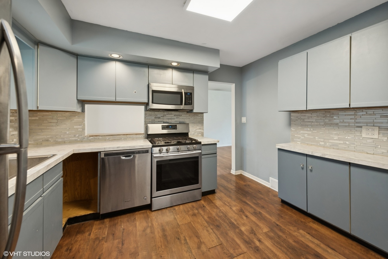 2 Northcrest Road Lake Zurich, IL 60047 - Photo 12 of 30 a kitchen with stainless steel appliances granite countertop a stove a sink and a microwave