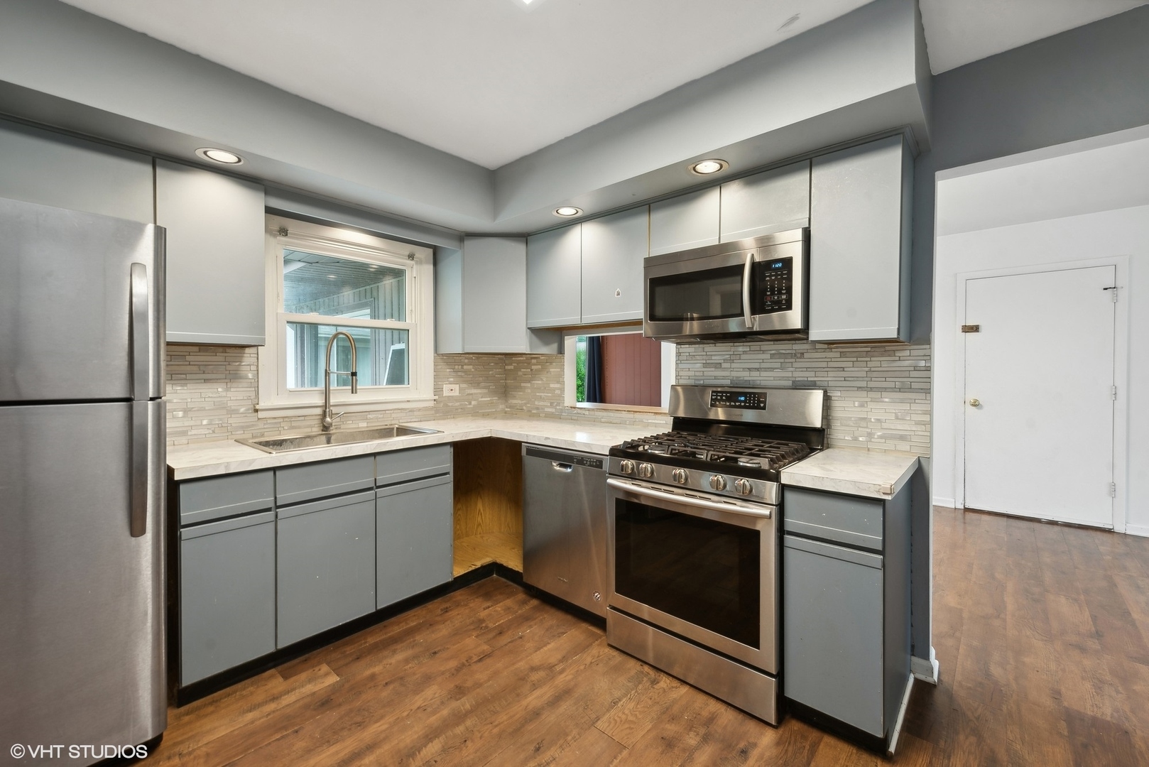 2 Northcrest Road Lake Zurich, IL 60047 - Photo 13 of 30 a kitchen with stainless steel appliances granite countertop a stove a sink and a microwave