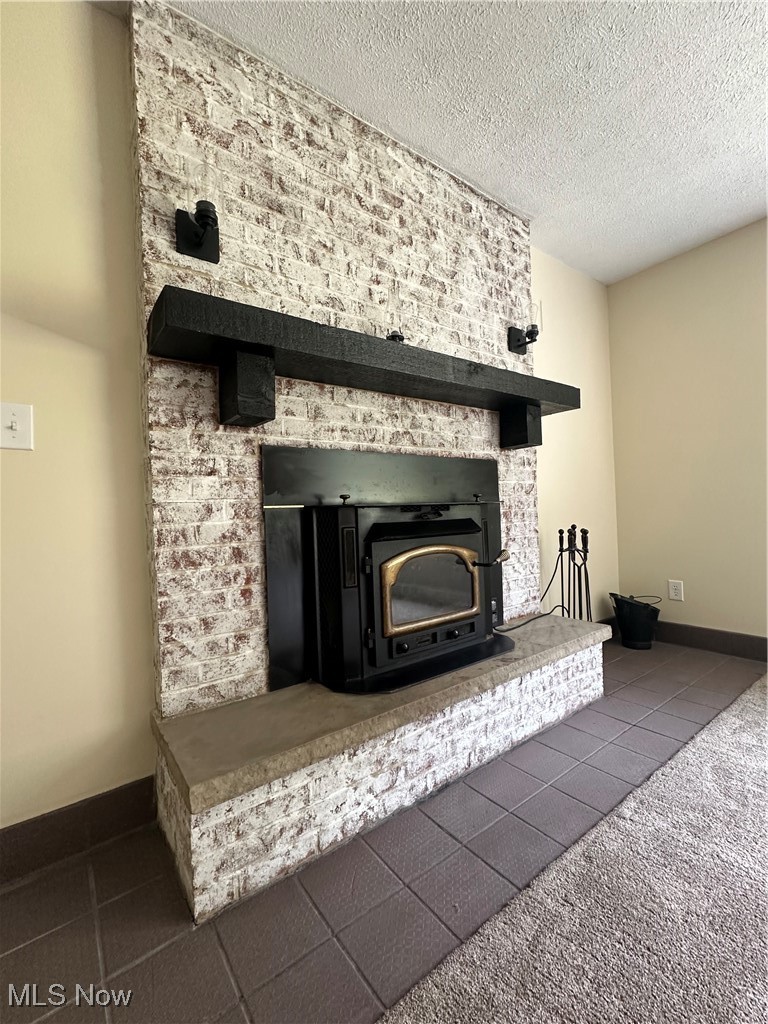 2372 Oak Grv Ext Road St. Marys, WV 26170 - Photo 5 of 23 Details featuring a fireplace, carpet, and a textured ceiling