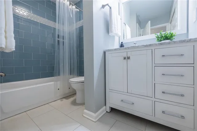 a bathroom with a bathtub a sink a toilet and a mirror