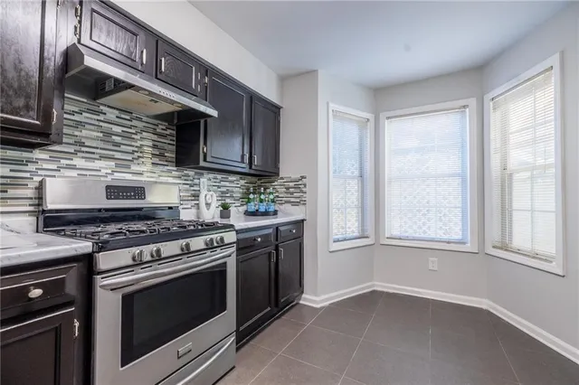a kitchen with stainless steel appliances granite countertop a stove and a microwave