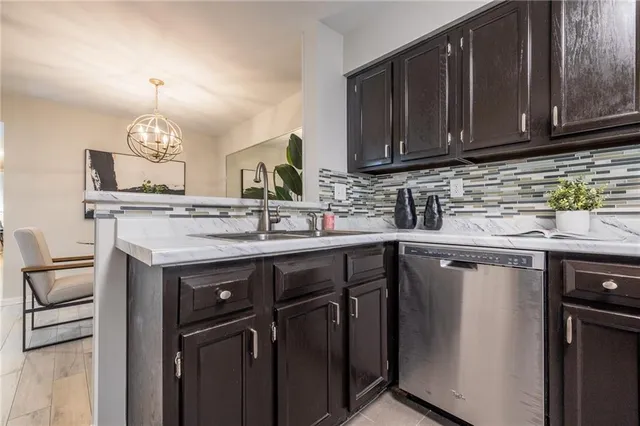 a kitchen with stainless steel appliances granite countertop a sink stove and cabinets