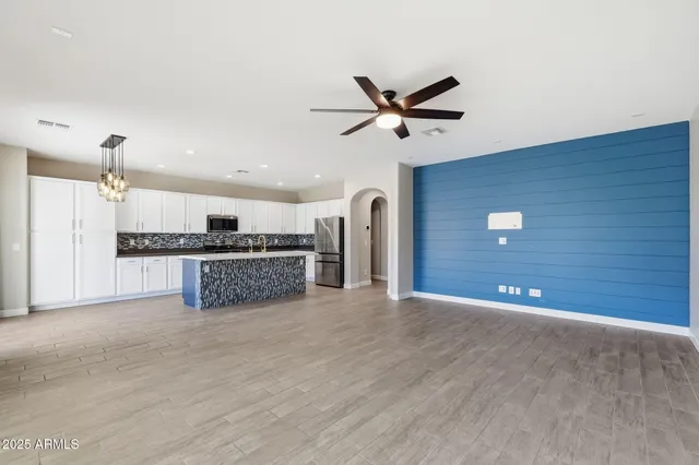 a view of a kitchen with a sink and a ceiling fan