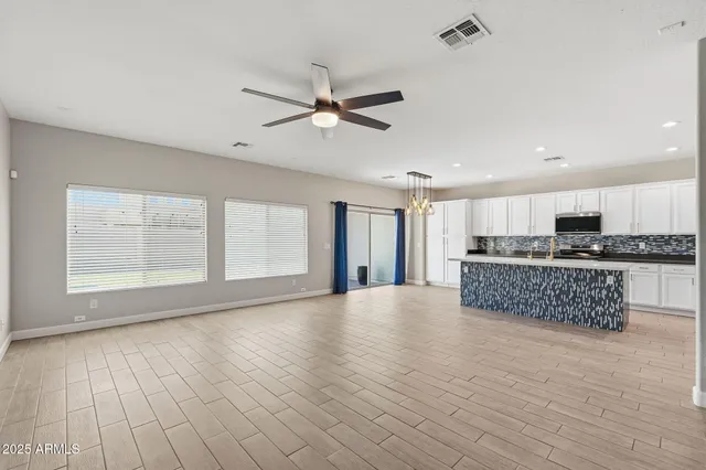 a large kitchen with stainless steel appliances granite countertop a stove a sink and a refrigerator