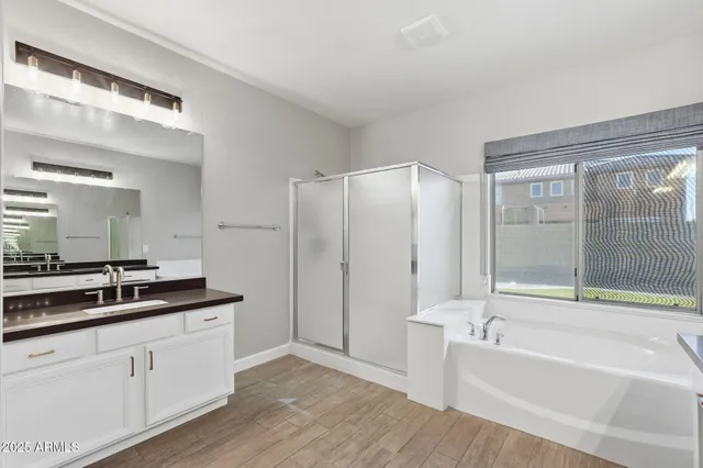 a bathroom with a tub and a shower