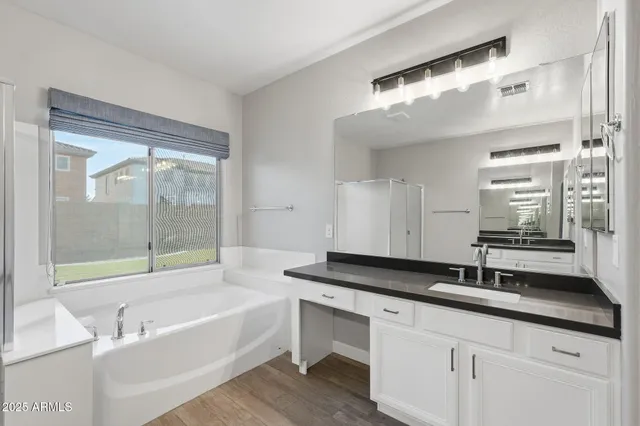 a hallway view with wooden floor and cabinets