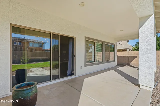 a view of a house with backyard sitting area and garden