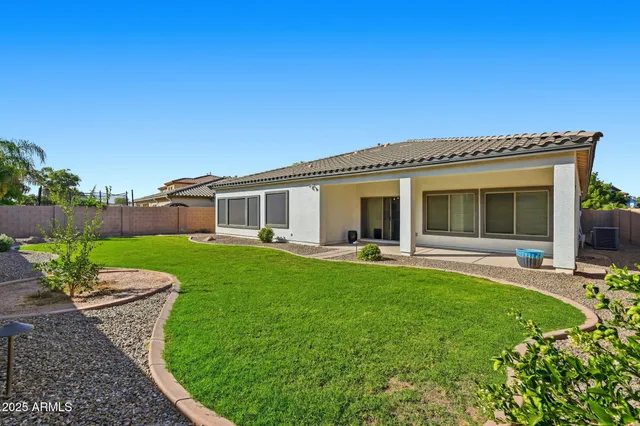a view of a backyard with plants and a backyard