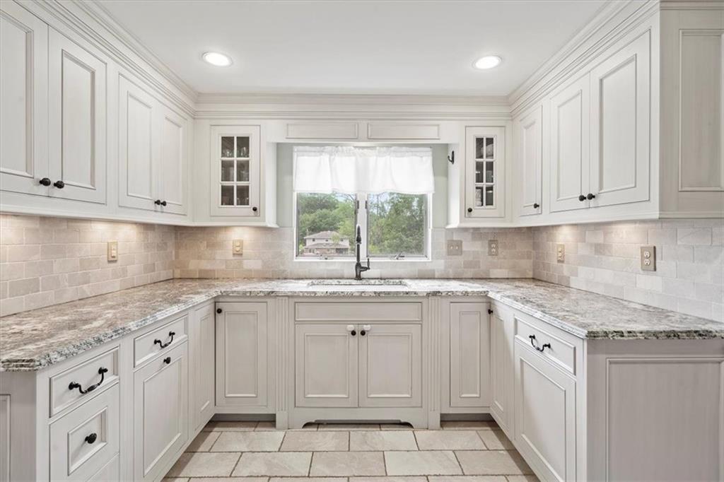 367 Sunset Road Pittsburgh, PA 15237 - Photo 17 of 37 a kitchen with white cabinets appliances a sink and a window