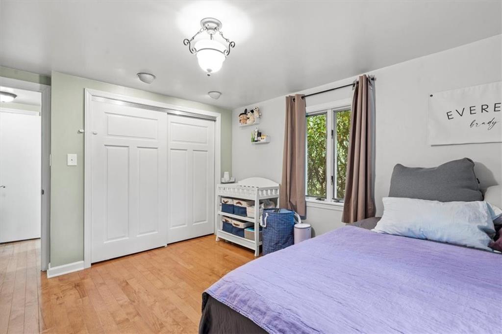 367 Sunset Road Pittsburgh, PA 15237 - Photo 22 of 37 a bedroom with a large bed and a chandelier