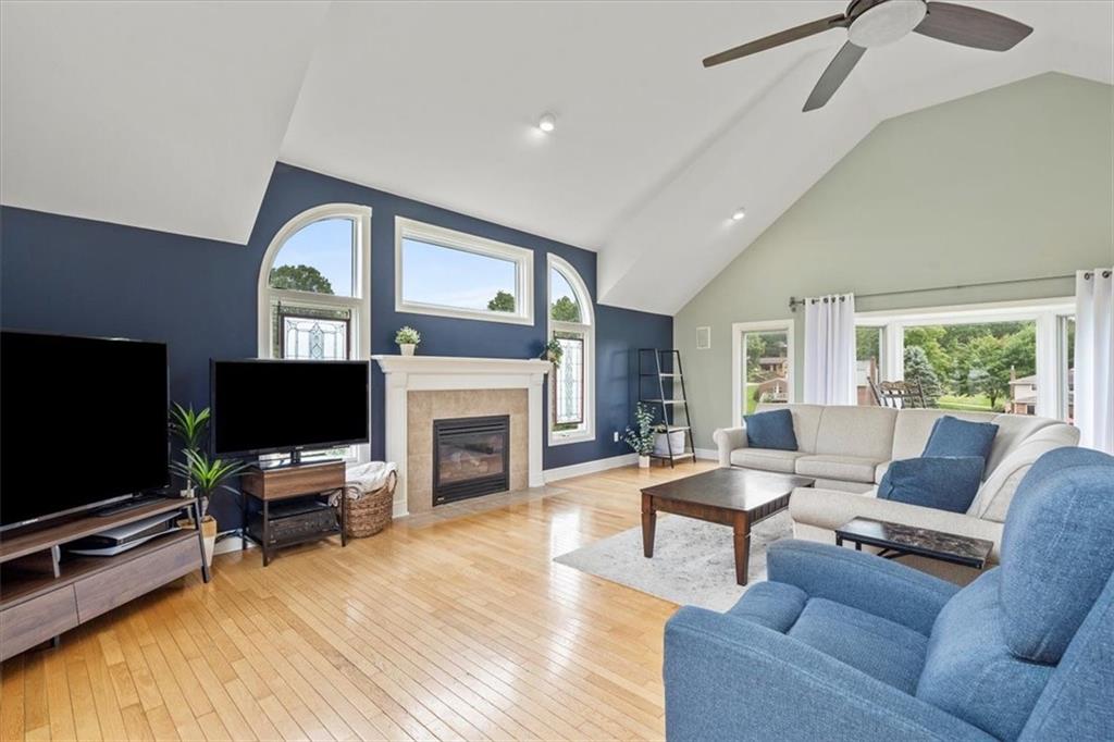 367 Sunset Road Pittsburgh, PA 15237 - Photo 8 of 37 a living room with furniture a fireplace and a flat screen tv