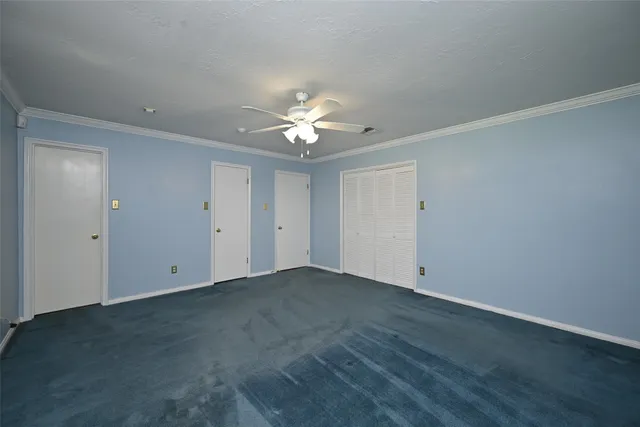 a view of an empty room with a ceiling fan