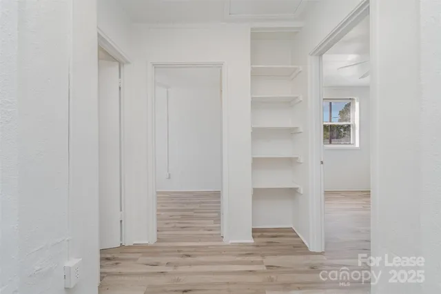 a view of entryway and hall with wooden floor