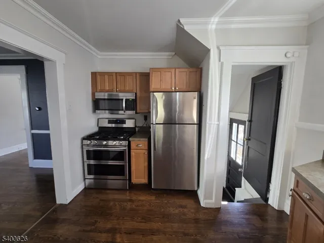 a kitchen with a refrigerator and a stove