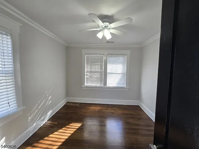 a view of wooden floor and windows in a room