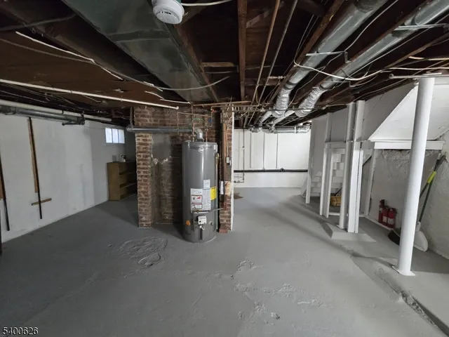 a view of water heater room with refrigerator