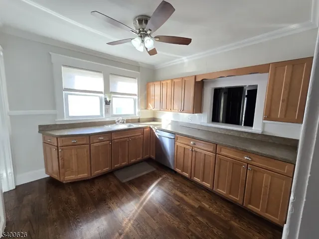 a kitchen with a sink window and cabinets