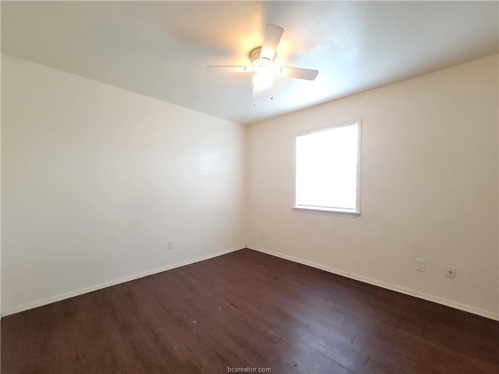 2712 Evergreen Circle Bryan, TX 77801 - Photo 27 of 30 Empty room with dark hardwood / wood-style floors and ceiling fan