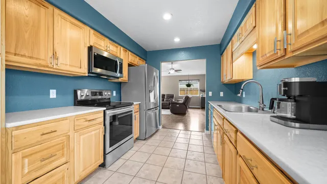 a kitchen with stainless steel appliances granite countertop a sink and a stove