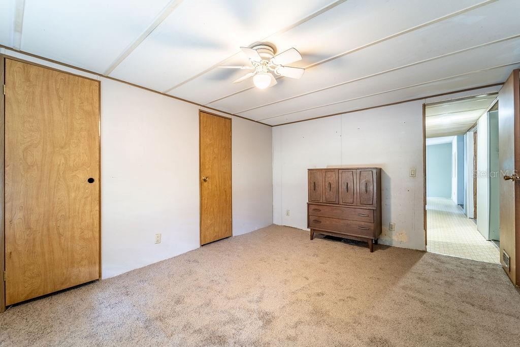 24031 Armadillo Road Astor, FL 32102 - Photo 30 of 43 a view of an empty room with cabinet and a ceiling fan