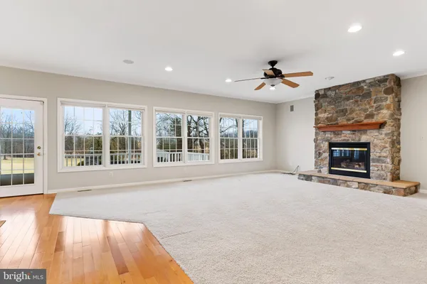 a view of an empty room with a fireplace and a large window