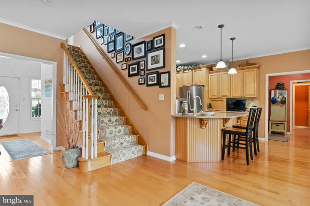 a dining room with furniture a chandelier and wooden floor