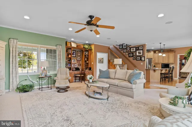 a dining hall with stainless steel appliances kitchen island granite countertop a table and chairs