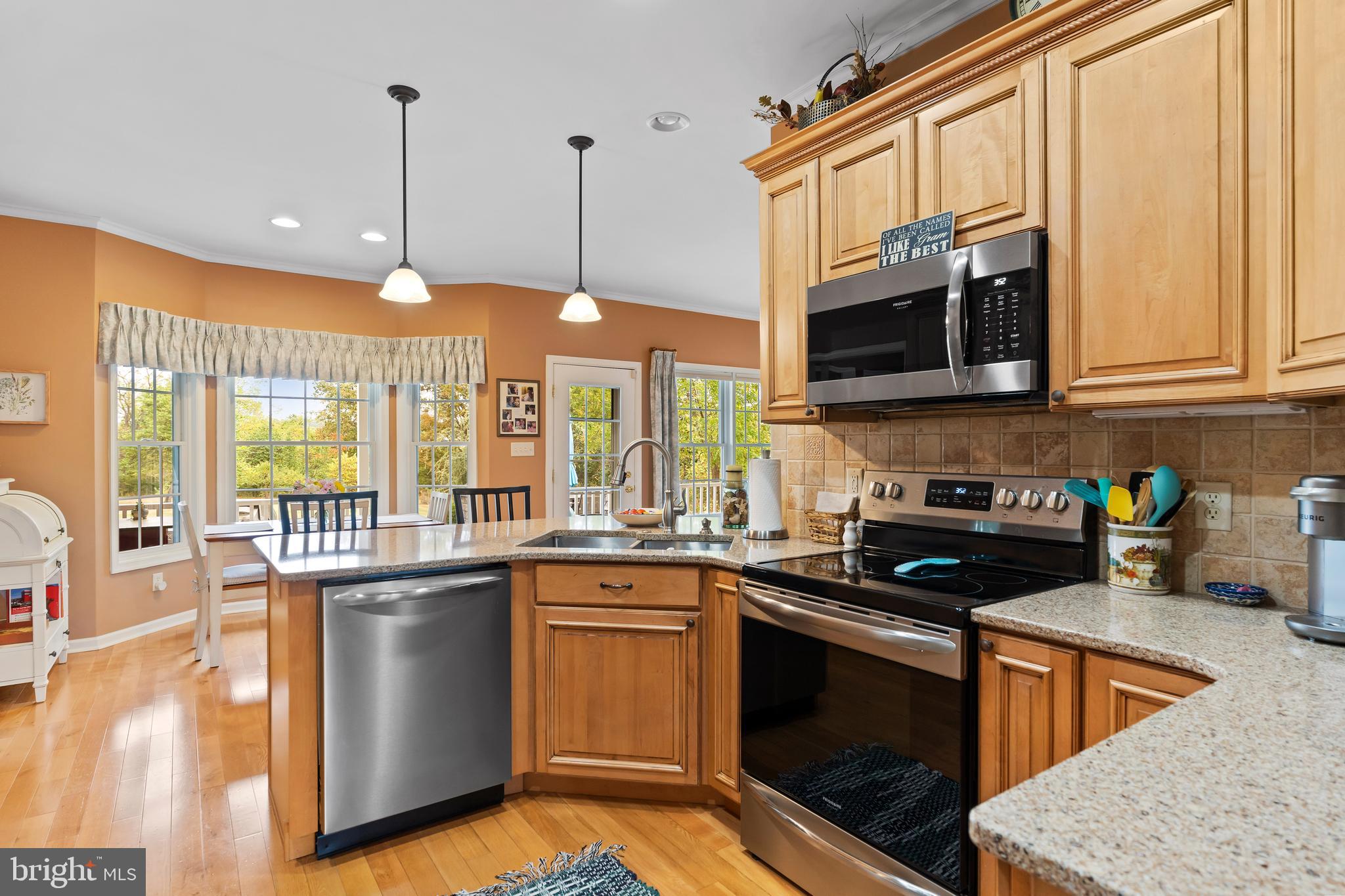 2562 Echo Springs Road, Unit 35 Chambersburg, PA 17202 - Photo 23 of 50 a kitchen with stainless steel appliances granite countertop a stove a sink and a microwave