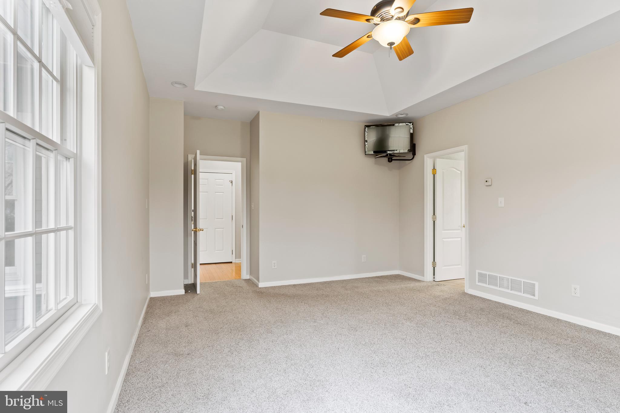 2562 Echo Springs Road, Unit 35 Chambersburg, PA 17202 - Photo 29 of 50 an empty room with windows and ceiling fan