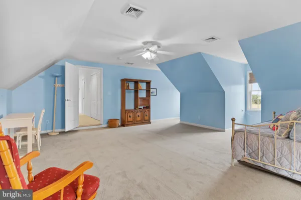 a view of a storage room with furniture and a ceiling fan