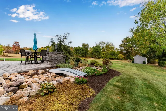 a view of a backyard with sitting area