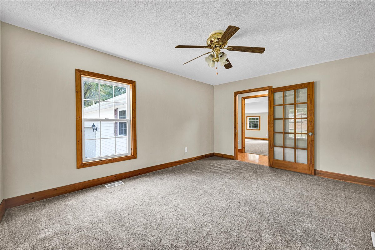 116 Lakeview Road East Galesburg, IL 61430 - Photo 4 of 36 a view of an empty room with chandelier fan and a window