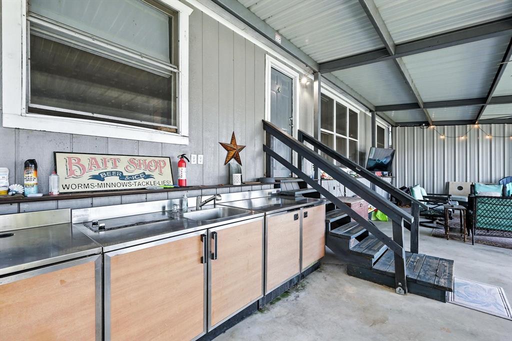 150 Red Bluff Loop Mabank, TX 75156 - Photo 12 of 26 a kitchen with stainless steel appliances granite countertop a sink and a microwave