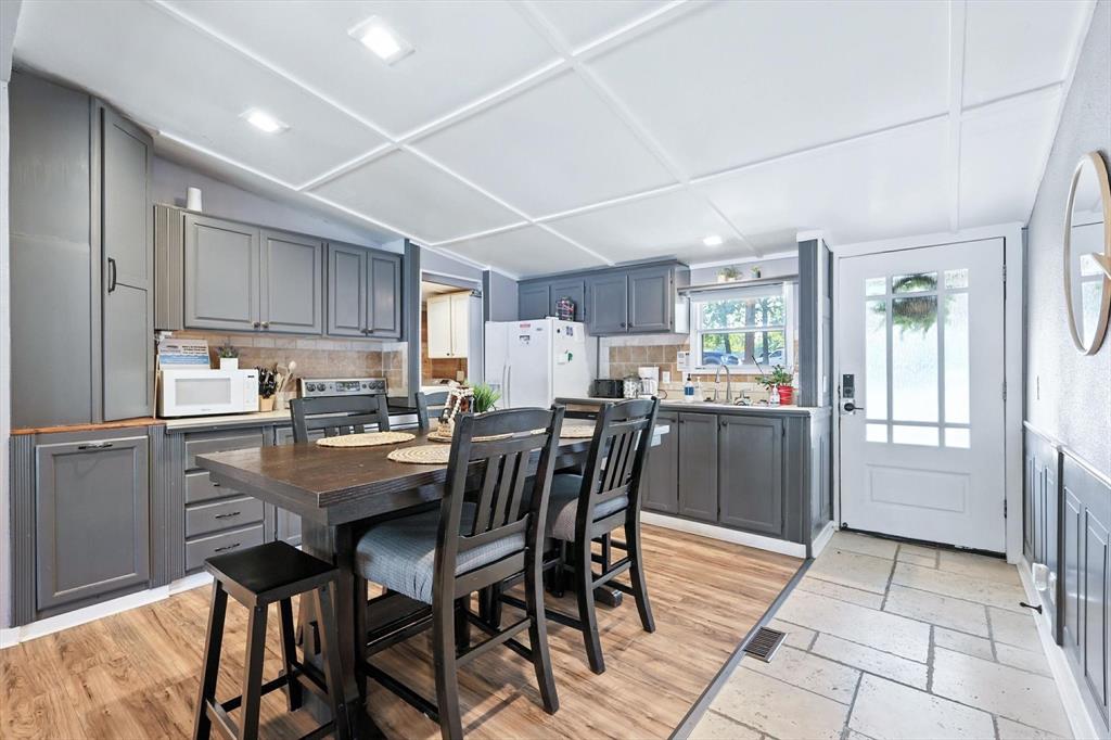 150 Red Bluff Loop Mabank, TX 75156 - Photo 19 of 26 a kitchen with a table chairs refrigerator and cabinets