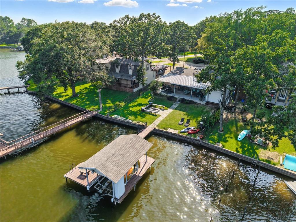 150 Red Bluff Loop Mabank, TX 75156 - Photo 2 of 26 an aerial view of a house with swimming pool a yard and lake view